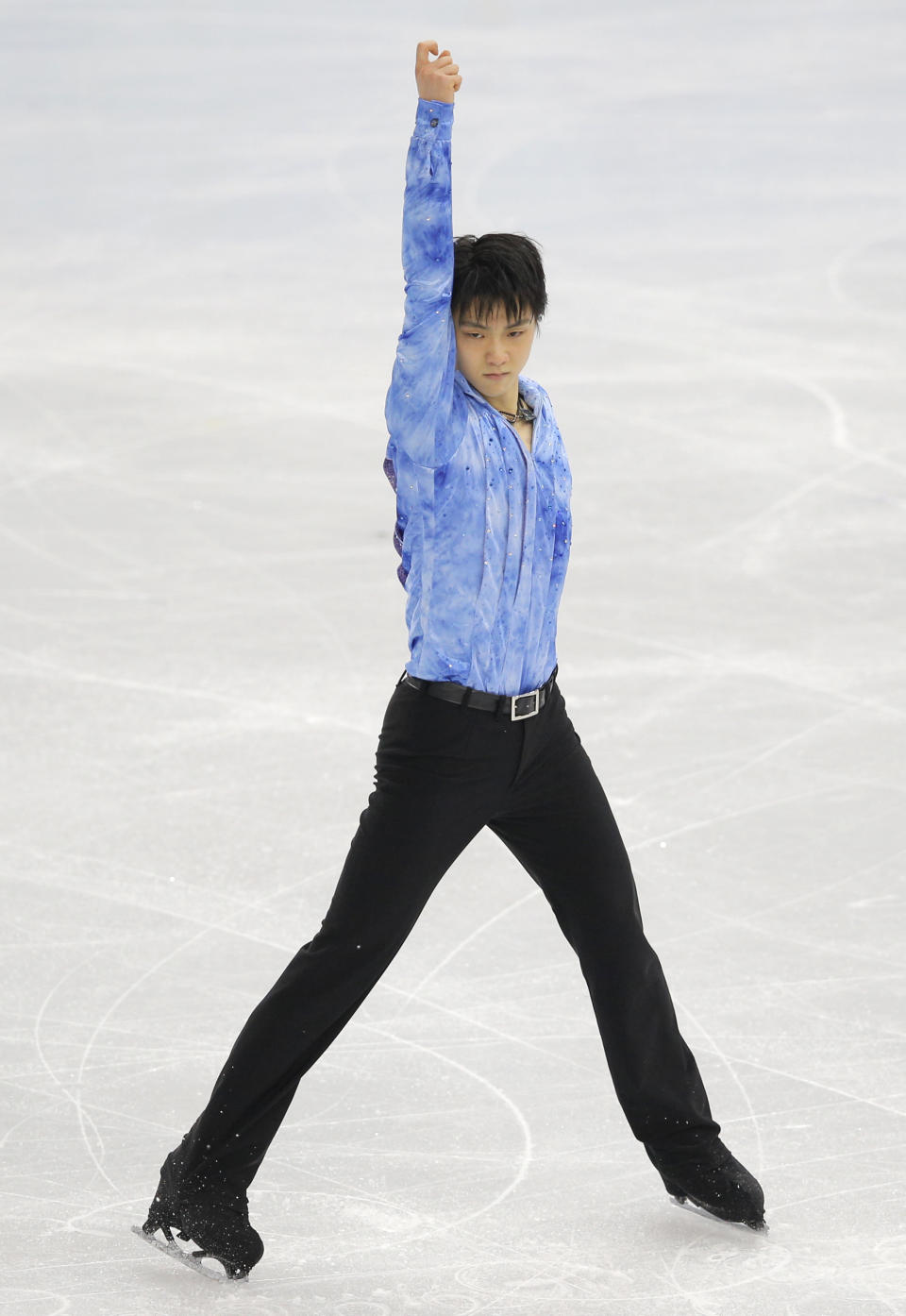 Yuzuru Hanyu of Japan competes in the men's short program figure skating competition at the Iceberg Skating Palace at the 2014 Winter Olympics, Thursday, Feb. 13, 2014, in Sochi, Russia. (AP Photo/Vadim Ghirda)