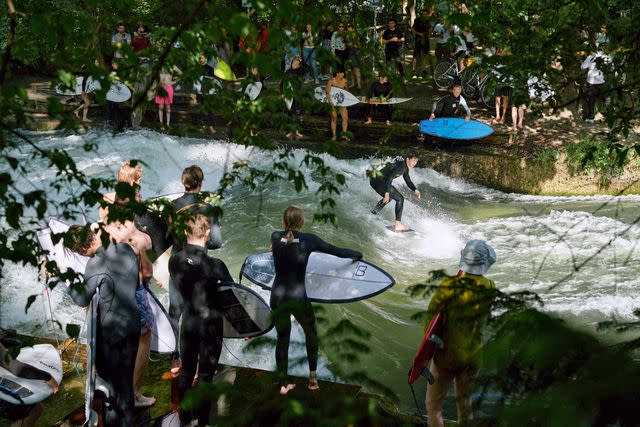 <p>Christian Kane</p> Surfers wait to drop in at the Eisbach.