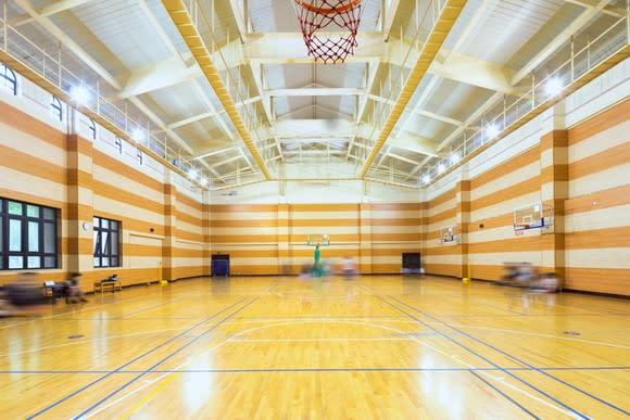 Brightly lit, contemporary indoor basketball court