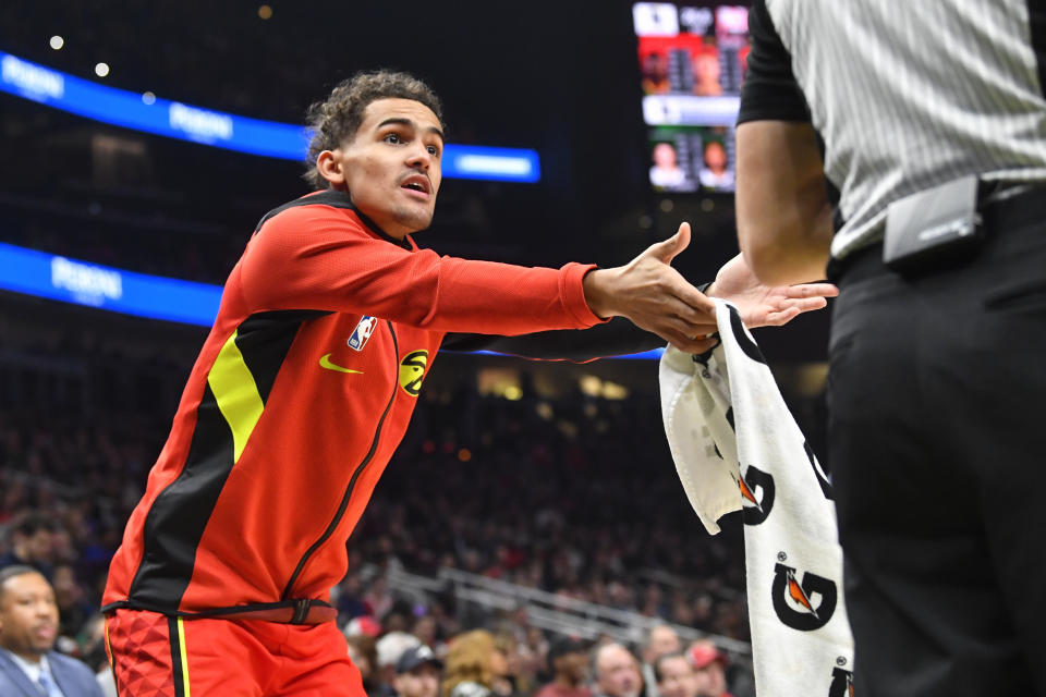 Atlanta Hawks guard Trae Young, left, pleads for a call from an official during the first half of an NBA basketball game against the Milwaukee Bucks, Friday, Dec. 27, 2019, in Atlanta. (AP Photo/John Amis)
