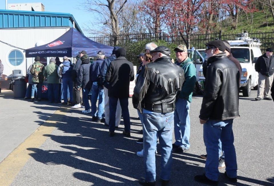 People wait in line to get something hot from the Dietz and Watson tent at the Camden Waterfront.