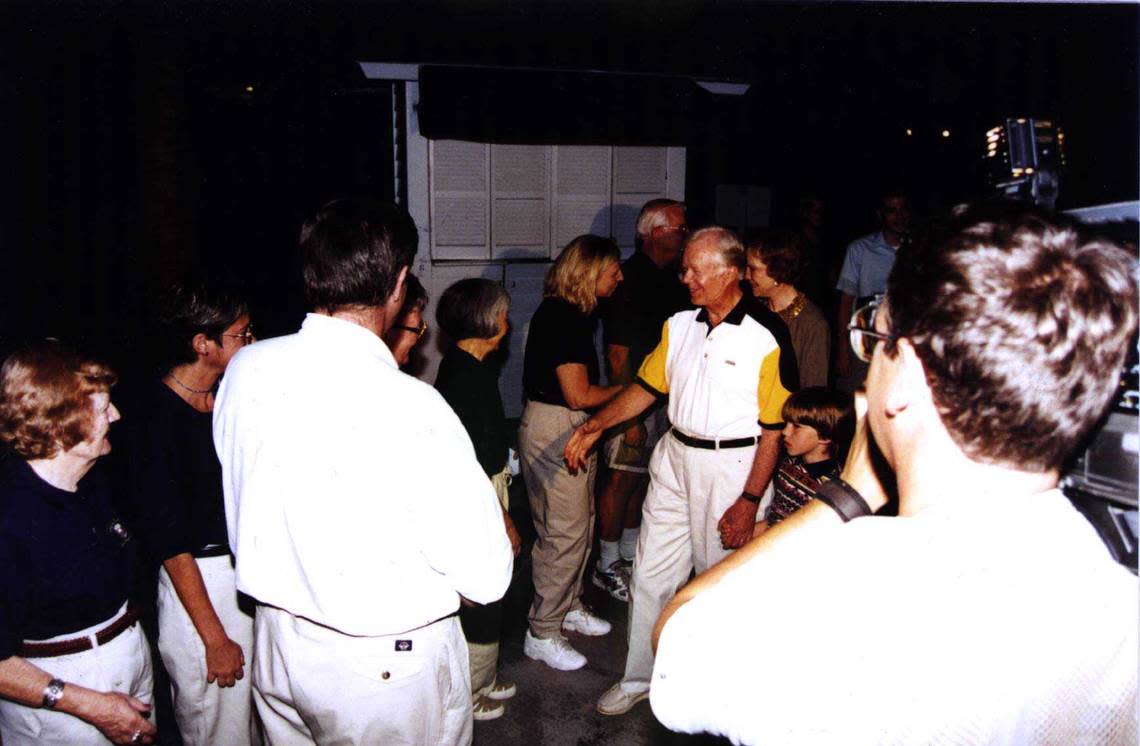 Former President Jimmy Carter greets people outside the Little White House on New Year’s Eve in 1996.