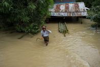 <p>A man wades through a flooded road in Taungnu township of Bago region in Myanmar on Aug. 31, 2018. (Photo: Ye Aung Thu/AFP/Getty Images) </p>