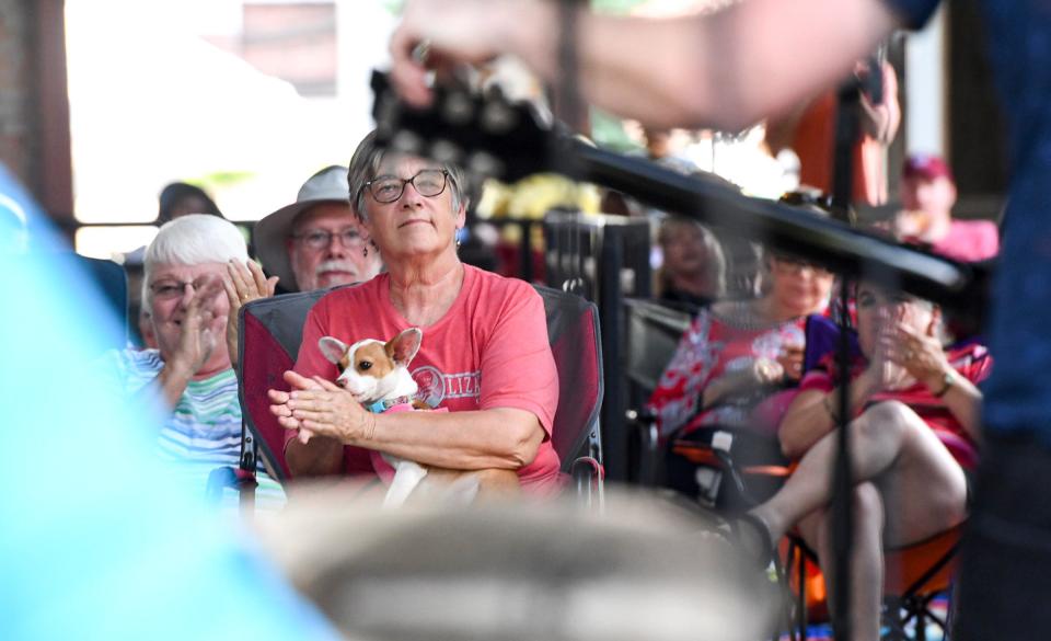 Karen Riley holds Mabel the Chihuahua while clapping for Nathan Angelo and his band, during the fourth week of the 2024 season of Piedmont Natural Gas Block Party in downtown Anderson, S.C. May 23. The 16 date season has bands each Thursday 6 p.m., except July 4, through August 25.