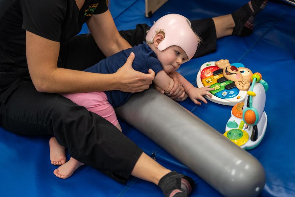 Madelynn does strengthening exercises to help catch up on her developmental milestones with Physical Therapist Jenae Swiercz.