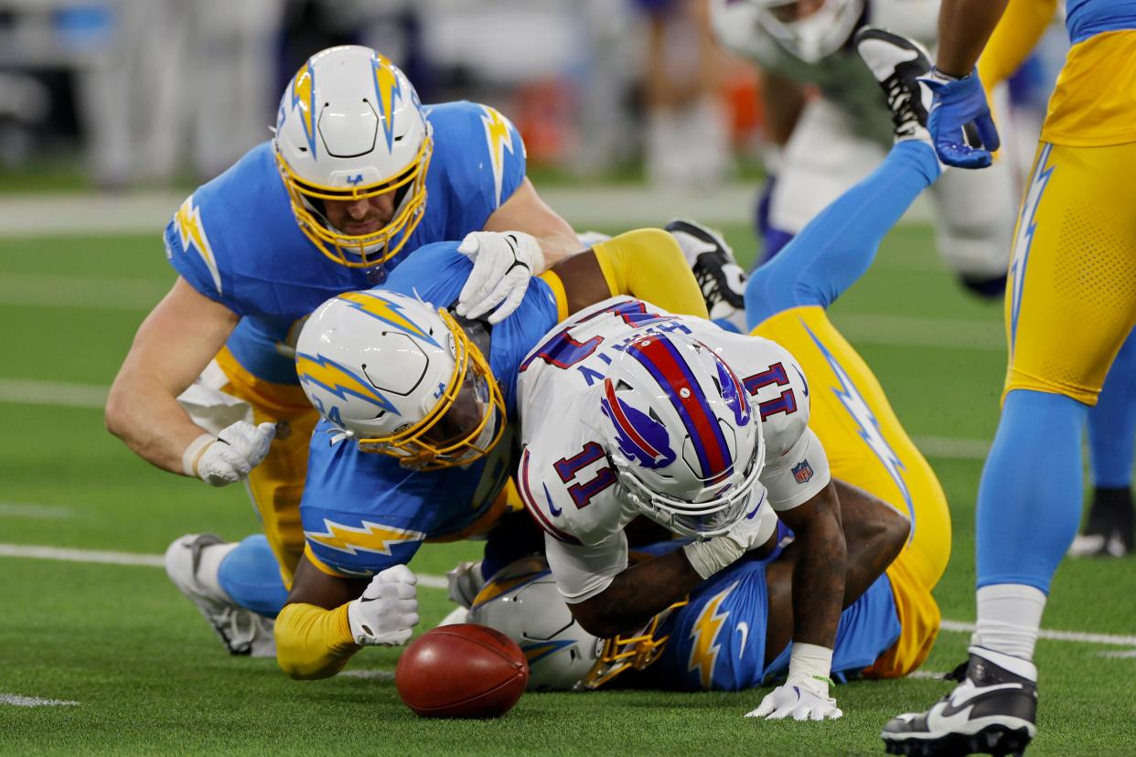 INGLEWOOD, CALIFORNIA - DECEMBER 23: AJ Finley #24 of the Los Angeles Chargers forces a fumble by Deonte Harty #11 of the Buffalo Bills in the first quarter at SoFi Stadium on December 23, 2023 in Inglewood, California. (Photo by Kevork Djansezian/Getty Images)