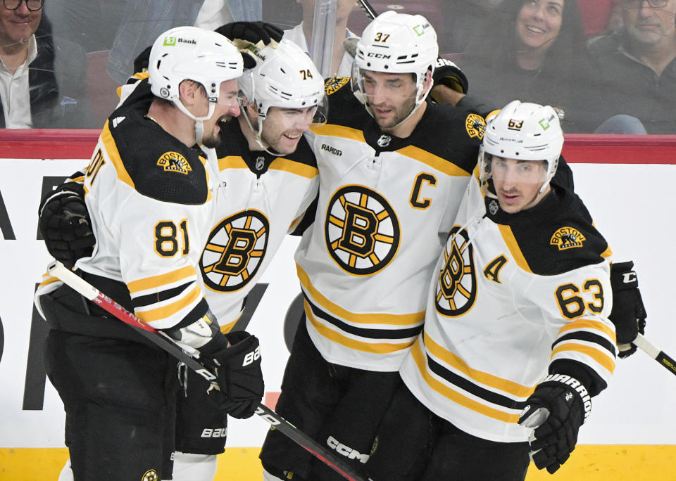 Boston Bruins' Jake DeBrusk (74) celebrates with teammates after scoring against the Montreal Canadiens during the first period of an NHL hockey game Thursday, April 13, 2023, in Montreal. (Graham Hughes/The Canadian Press via AP)