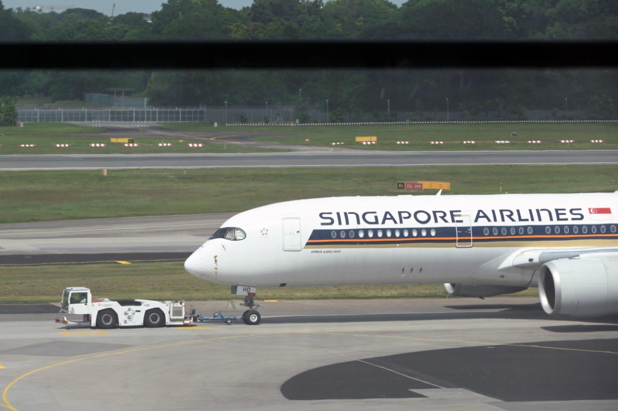 Singapore Airlines passenger plane is towed to the terminal area of Changi International Airport in Singapore on December 7, 2020. (Photo by Roslan RAHMAN / AFP) (Photo by ROSLAN RAHMAN/AFP via Getty Images)