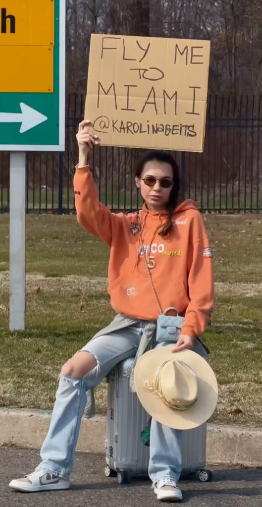 Geits toted around a cardboard sign with the brazen request, “Fly me to Miami,” outside of Teterboro Airport in New Jersey. Courtesy of Karolina Geits