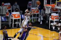 New Orleans Pelicans forward Brandon Ingram (14) shoots over Los Angeles Lakers forward Anthony Davis during the first quarter of an NBA basketball game Friday, Jan. 15, 2021, in Los Angeles. (AP Photo/Ashley Landis)