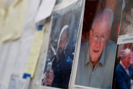 Pictures of people missing in the aftermath of the Camp Fire are posted at an evacuation center in Chico, California, U.S., November 15, 2018. REUTERS/Terray Sylvester