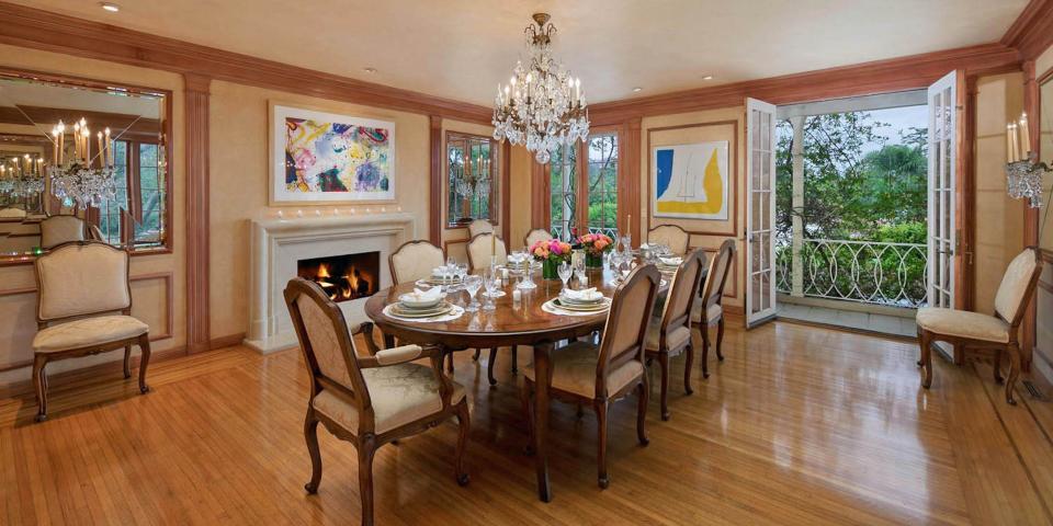 a formal dining table surrounded by windows