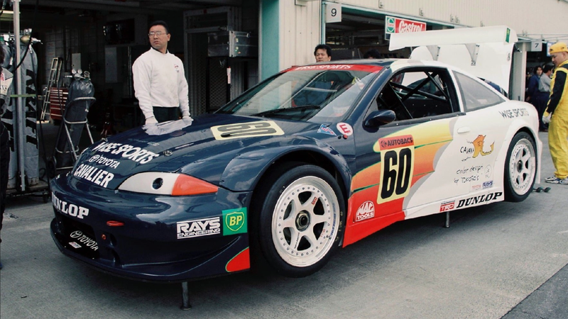 a toyota cavalier race car in the pit box at a race track in the late 19902