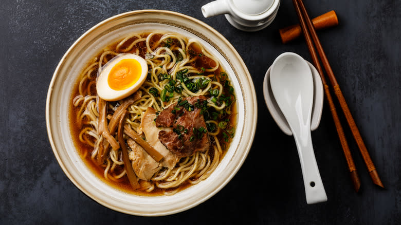 bowl of yakamein with soup and chopsticks