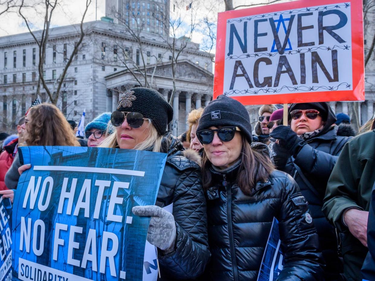 Participants hold up signs reading "No Hate. No Fear" and "Never again" in New York City on January 5, 2020, at the No Hate No Fear solidarity march against the rise of anti-semitism.