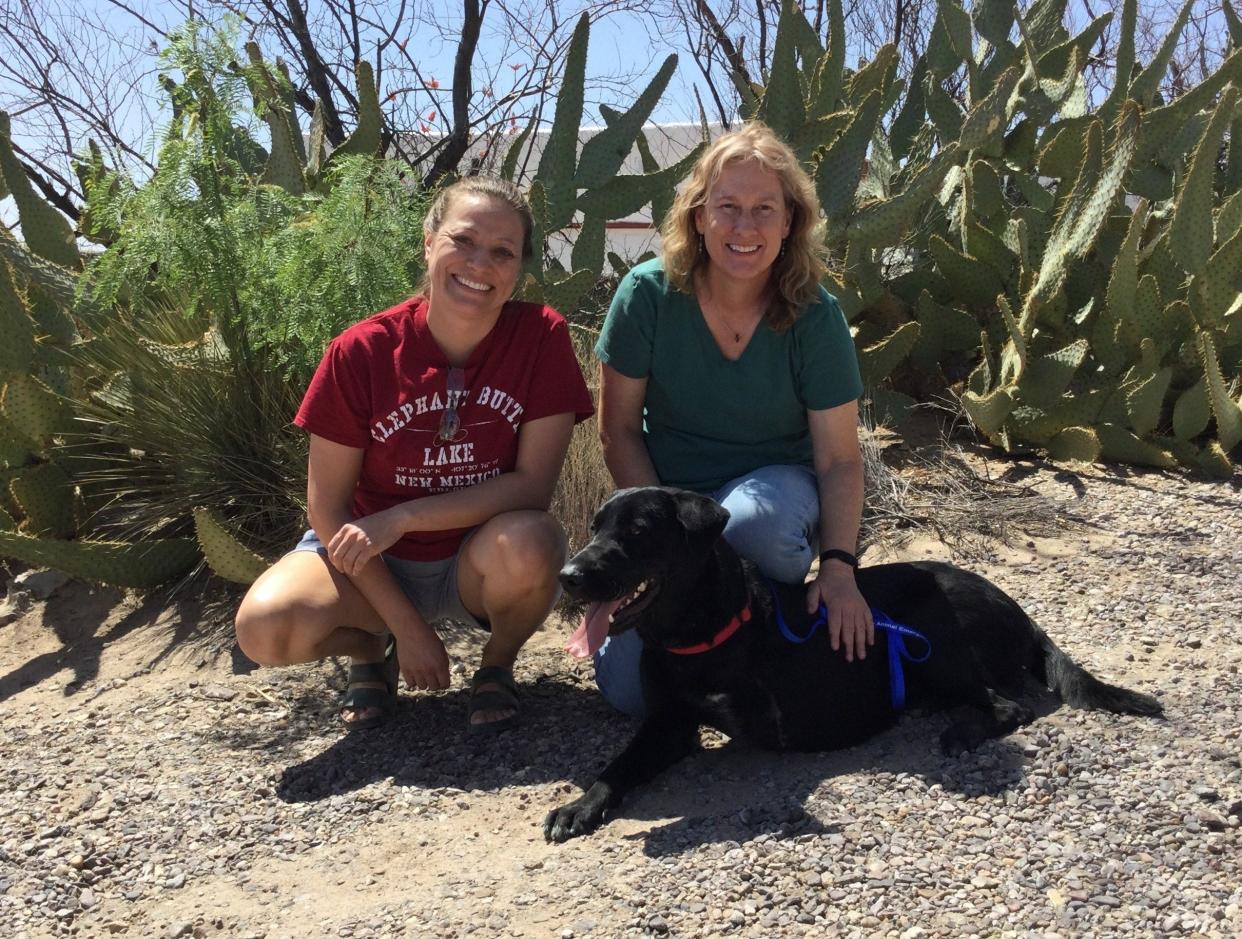 Yadi relaxes with his human mom Brandi Sanchez and rescuer Trish Cutler.