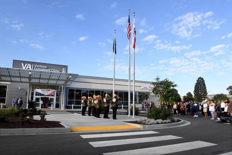 Members of the Vietnam Veterans of Ventura County salute as the U.S., California and veterans flags are raised for the official opening of the long-awaited VA clinic in Ventura on Tuesday.