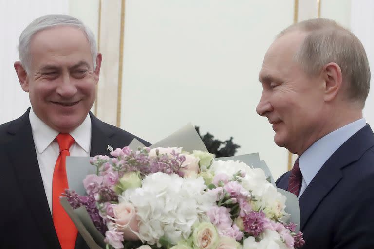 El presidente ruso Vladímir Putin, derecha, se prepara para saludar a la esposa del primer ministro israelí Benjamin Netanyahu, Sara, quien no aparece en la foto, antes de conversar con Netanyahu en el Kremlin, el 30 de enero de 2020