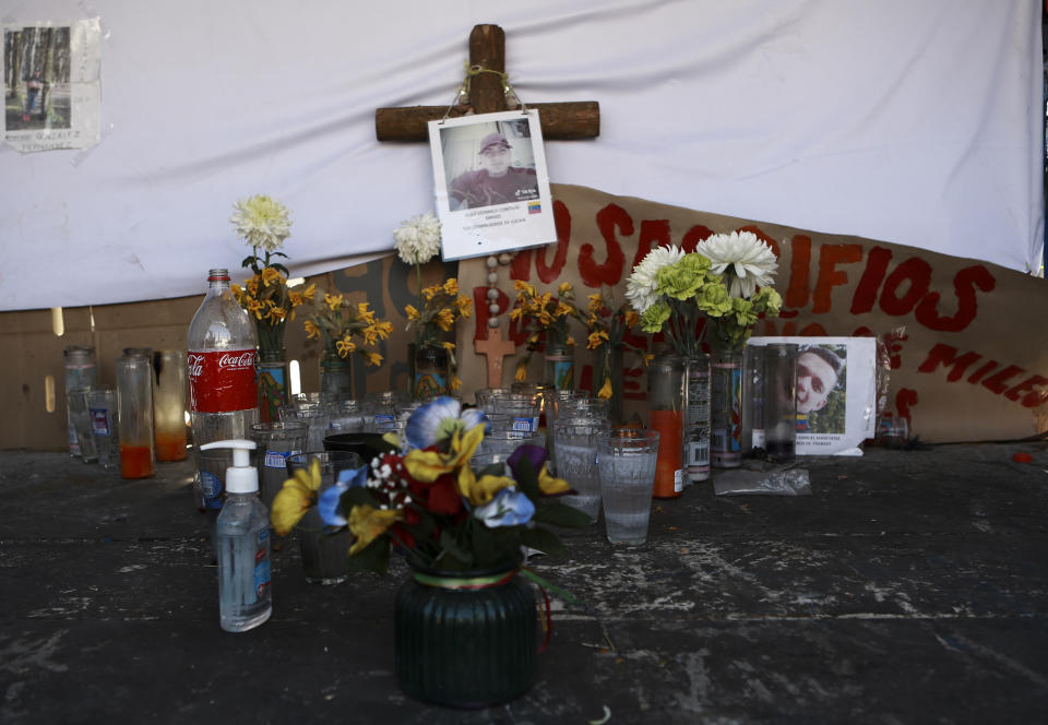 A makeshift altar in honor of migrants who died in last month's fire, sits outside the immigration detention center where a dormitory fire killed more than three dozen people, in Ciudad Juarez, Mexico, Thursday, April 20, 2023. (AP Photo/Christian Chavez)