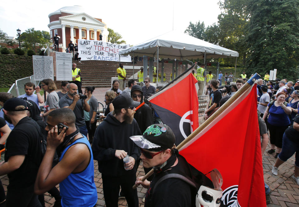 FILE - In this Saturday, Aug. 11, 2018 file photo, a group of anti-fascist and Black Lives Matter demonstrators march in front of the Rotunda on the campus of the University of Virginia in anticipation of the anniversary of the previous year's Unite the Right rally in Charlottesville, Va. Rutgers University historian Mark Bray, author of the book “Antifa: The Anti-Fascist Handbook,” said there are well organized, tightly knit antifa groups that have operated for years. “But that’s different from saying that the politics of antifa is just one single, monolithic organization, which is obviously false,” said Bray, whose book traces the history and evolution of the movement. (AP Photo/Steve Helber)