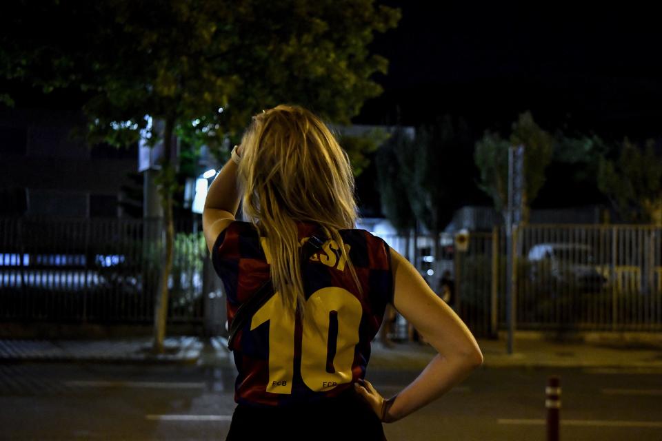 A fan wearing a jersey of Barcelona's Argentinian forward Lionel Messi gestures as supporters gather in front of the Camp Nou stadium in Barcelona on August 5, 2021. - Lionel Messi will end his 20-year career with Barcelona after the Argentine superstar failed to reach agreement on a new deal with the club, the Spanish giants announced on August 5, 2021. (Photo by Pau BARRENA / AFP) (Photo by PAU BARRENA/AFP via Getty Images)