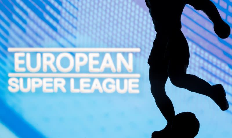 A metal figure of a football player with a ball is seen in front of the words "European Super League" in this illustration