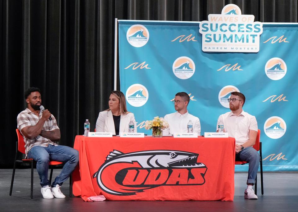 Raheem Mostert (far left) sits with three of the eight other panelists during the Waves of Success Summit at New Smyrna High School, Friday, May 19, 2023.