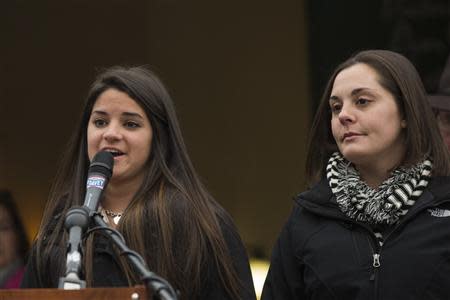 Carlee Soto (L), sister of Sandy Hook teacher Victoria Soto, and Erica Laffferty, daughter of Sandy Hook principal Dawn Hochsprung, announce that they will light a candle for them on the one year anniversary of the Sandy Hook Elementary School tragedy in Sandy Hook, Connecticut December 9, 2013. REUTERS/Lucas Jackson