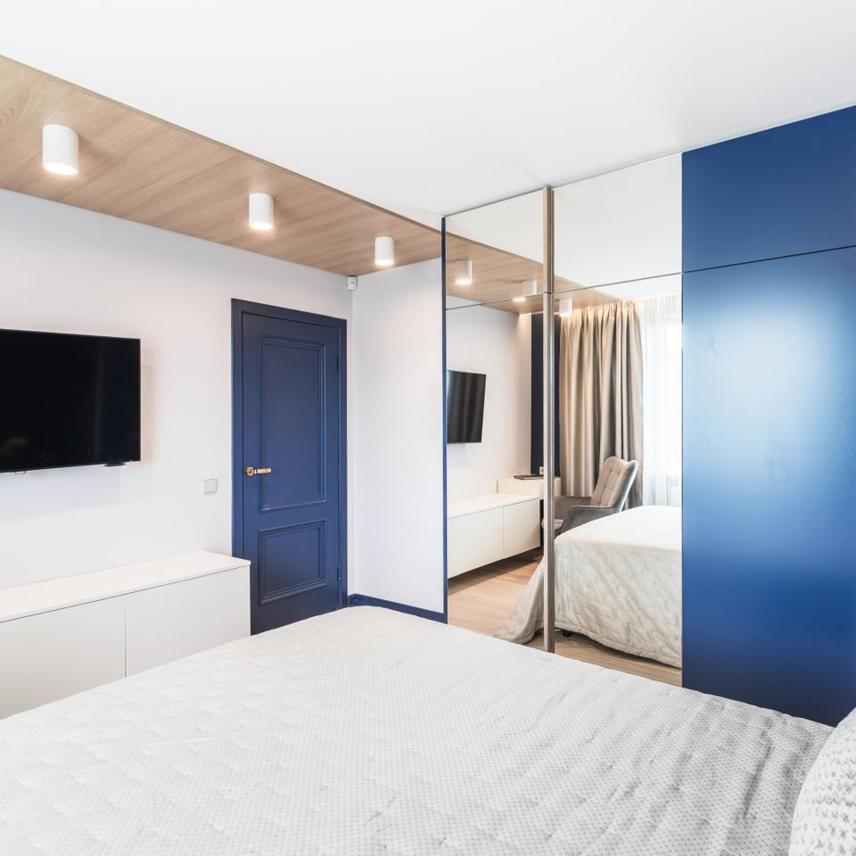 Blue mirrored wardrobe in bedroom