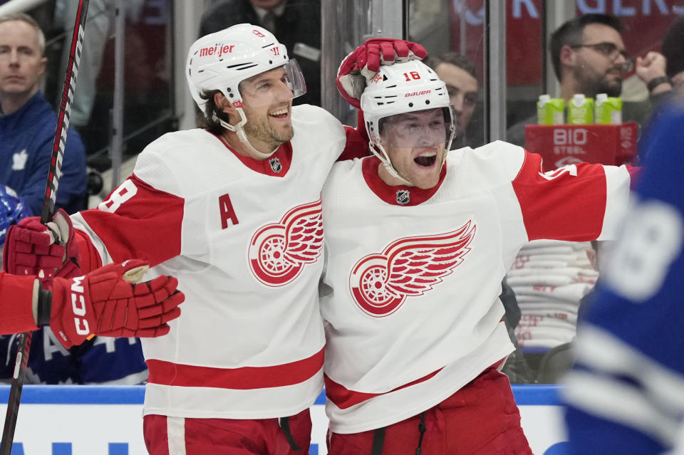 Detroit Red Wings centerAndrew Copp, right, celebrates after his goal against the Toronto Maple Leafs with teammate Ben Chiarot during third-period NHL hockey game action in Toronto, Sunday, Jan. 14, 2024. (Frank Gunn/The Canadian Press via AP)