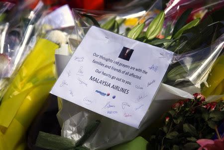 A bouquet of flowers from staff members of Malaysia Airlines is seen among floral tributes near the Lindt cafe, where hostages were held for over 16-hours, in central Sydney December 16, 2014. REUTERS/David Gray