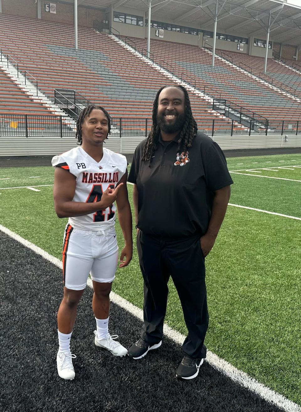 Shon Robinson poses for a picture with his dad, Anthony Robinson Jr., during Massillon football's 2023 media day. Anthony is a member of the coaching staff for the Tigers freshman team coaching staff.