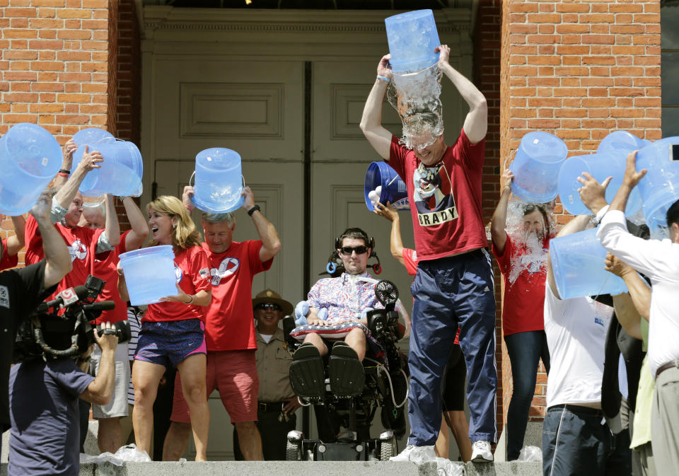 Massachusetts Gov. Charlie Baker, right center, and Lt. Gov. Karyn Polito, third from left, participate in the Ice Bucket Challenge with its inspiration Pete Frates, (center), to raise money for ALS research Monday, Aug. 10, 2015, at the Statehouse in Boston. (AP)