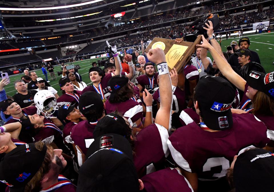 The Hawley Bearcats hold the Class 2A Div. I state football championship trophy over their heads after defeating Refugio at AT&T Stadium in Arlington Thursday Dec. 15, 2022. Final score was 54-28, Hawley.