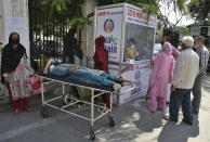 People wait to test for COVID-19 at a government hospital in Jammu, India, Monday, Oct.5, 2020. India, the second worst-affected nation in the world after the United States, is witnessing a sustained decline in new coronavirus infections and active virus cases have remained below the million mark for 14 consecutive days. (AP Photo/Channi Anand)