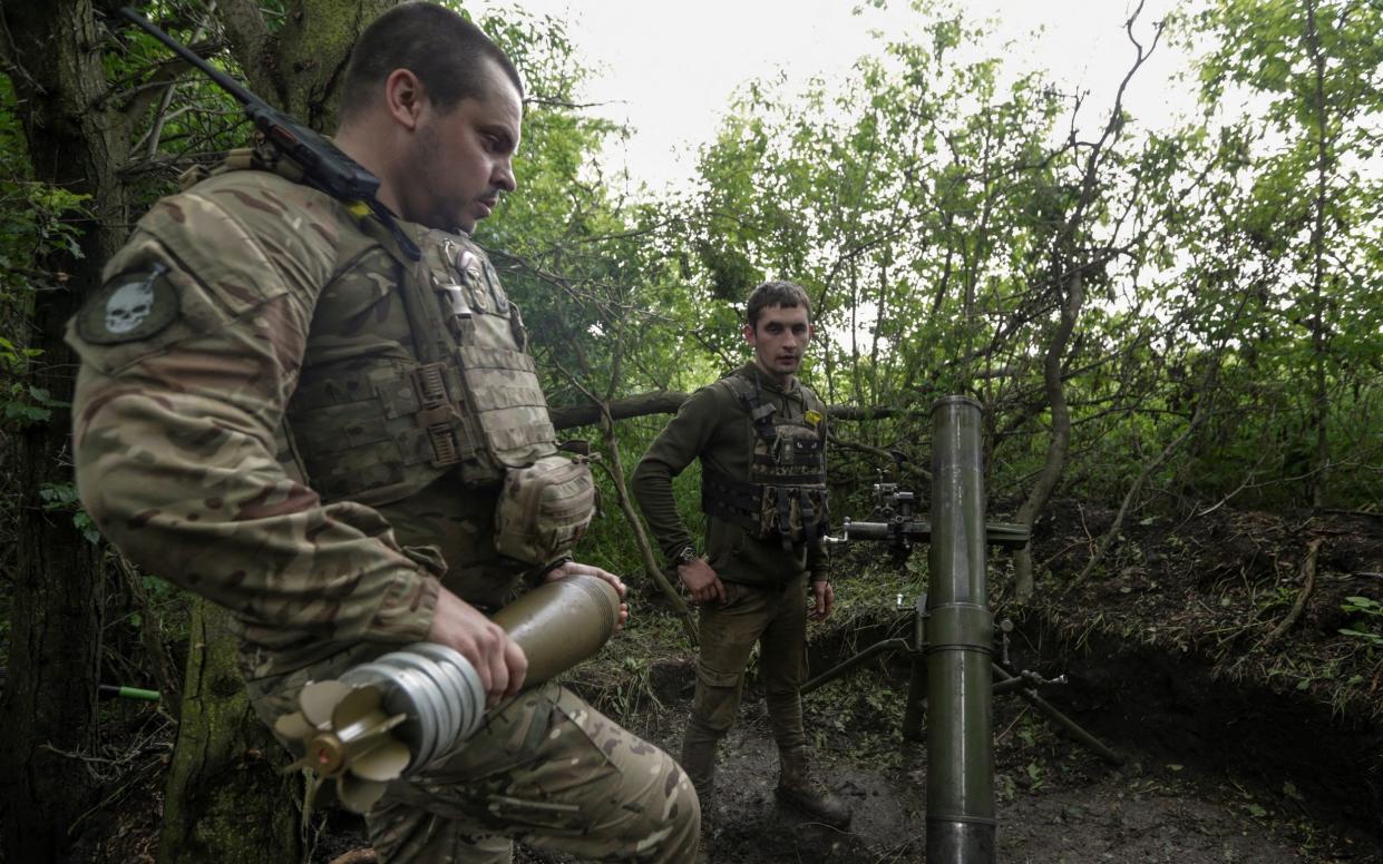 Ukrainian servicemen prepare to fire a mortar towards Russian troops near a front line in the Donetsk region - Anna Kudriavtseva/REUTERS