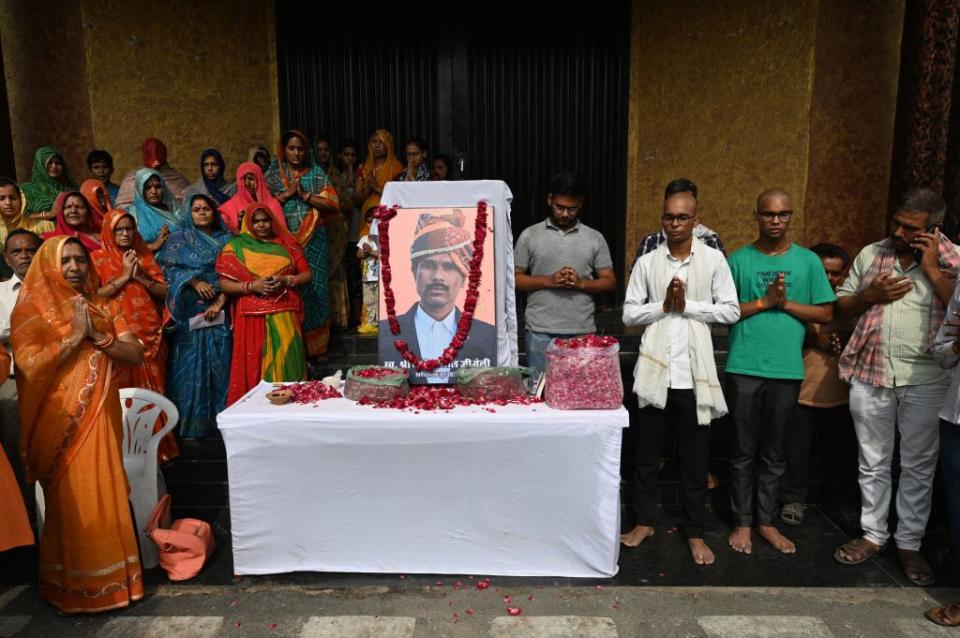 People pay their respects on June 30 to slain Hindu tailor Kanhaiya Lal, who was killed by two Muslim men.<span class="copyright">Sajjad Hussain/AFP—Getty Images</span>