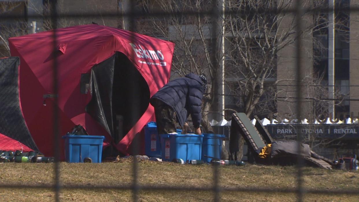 A camper packs up in Victoria Park on Monday. A news release from the Halifax Regional Municipality said the park was finally cleared on Friday. (CBC - image credit)