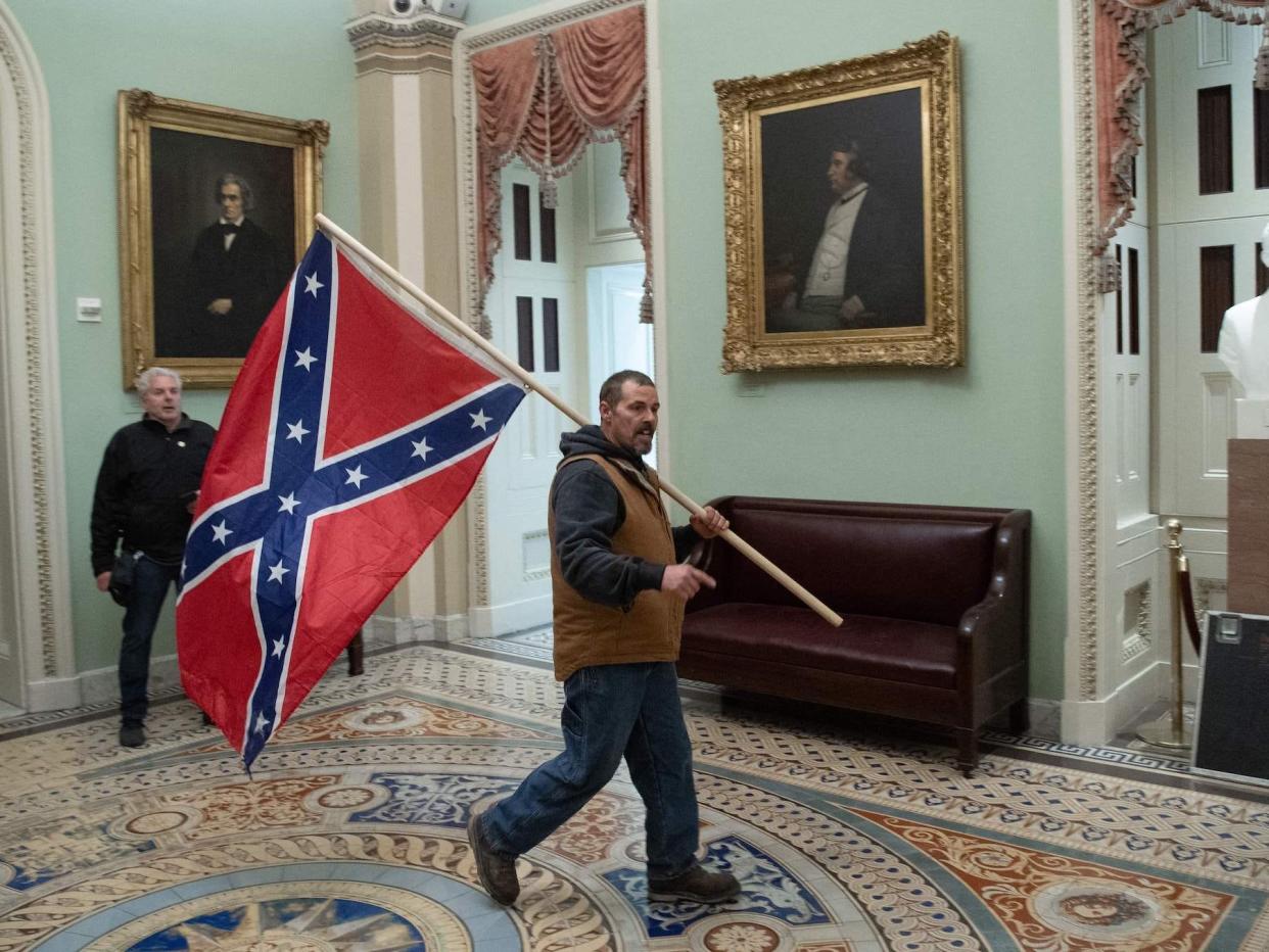 Kevin Seefried shown carrying the Confederate flag into the Capitol's rotunda on January 6, 2021.