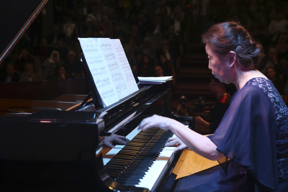 Japanese pianist Kaoru Imahigashi plays the piano during a concert to mark the debut of Gaza's only grand piano after it was rescued from conflict, at a theater nestled in the Palestinian Red Crescent Society's building in Gaza City, Sunday, Nov. 25, 2018. The only grand piano in the Gaza Strip is debuting to the public for the first time in over a decade after its restoration. (AP Photo/Adel Hana)