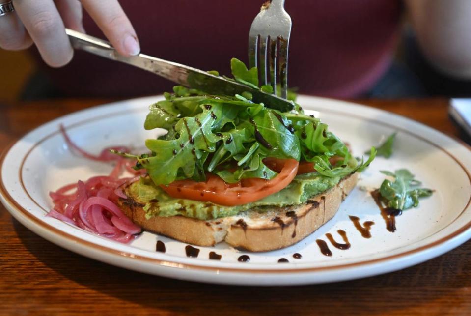 The avacado toast, sourdough toast topped with avocado, sliced tomato and arugula drizzled with a balsamic glaze and a side of pickled red onions, at Breakfast on Boal on Wednesday, May 17, 2023.