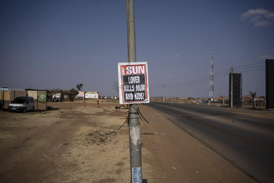 A poster with a local newspaper headline, "Lover Kills Mum and Kids!" is affixed to a pole on the side of a road in Johannesburg, South Africa, on Aug. 26, 2020. According to official figures, around 1,000 kids are murdered every year in South Africa, nearly three a day. But that statistic, horrific as it is, may be an undercount. (AP Photo/Bram Janssen)