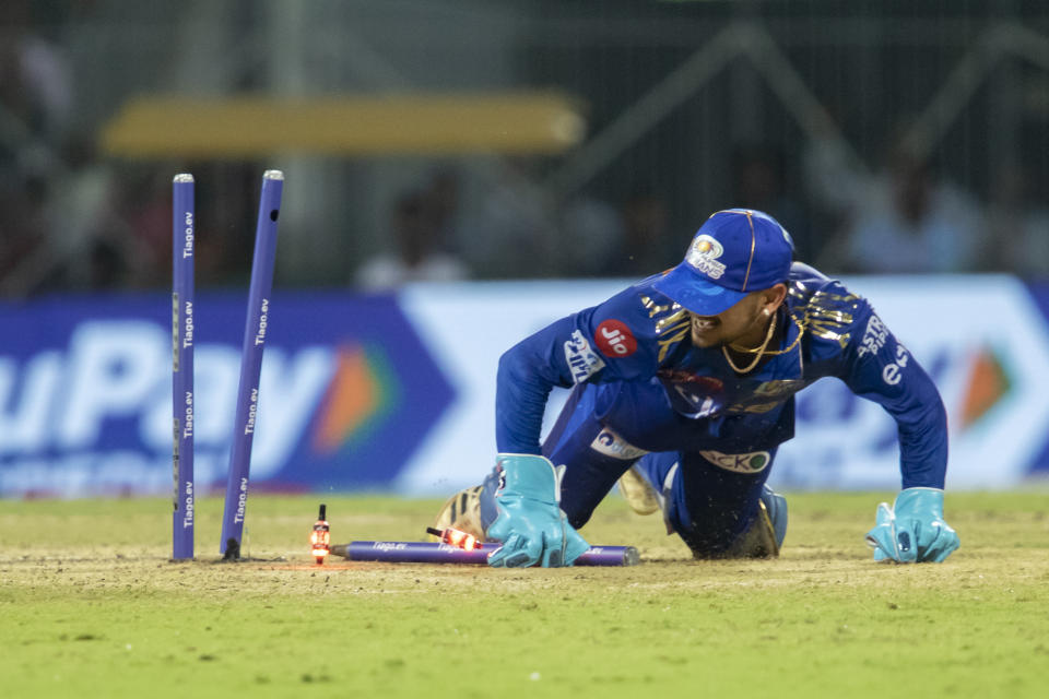 Mumbai Indians' Ishan Kishan dives to get Lucknow Super Giants' Marcus Stoinis run out during the Indian Premier League cricket eliminator match between Mumbai Indians and Lucknow Super Giants in Chennai, India, Wednesday, May 24, 2023. (AP Photo /R. Parthibhan)