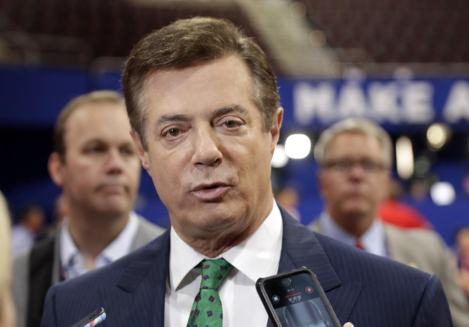 FILE - In this July 17, 2016 file photo, then-Donald Trump campaign chairman Paul Manafort talks to reporters on the floor of the Republican National Convention, in Cleveland. (AP Photo/Matt Rourke, File)