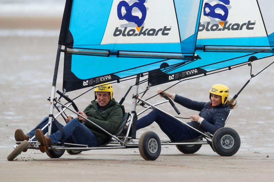 Britain's Prince William, Duke of Cambridge and Britain's Catherine, Duchess of Cambridge ride land yachts at West Sands beach, St Andrews in Scotland on May 26, 2021, during their visit to meet young carers and hear about the work of Fife Young Carers. (Photo by PHIL NOBLE / POOL / AFP) (Photo by PHIL NOBLE/POOL/AFP via Getty Images) ORG XMIT: 0 ORIG FILE ID: AFP_9AR87F.jpg