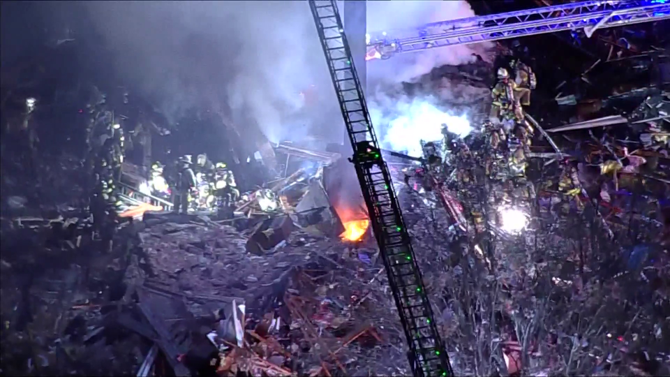Crews work the scene after a house exploded in Sterling, Virginia, Feb. 16, 2024, in this image capture from aerial footage. / Credit: WUSA-TV