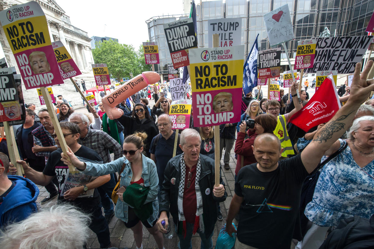 PORTSMOUTH, ENGLAND - JUNE 5: Protesters hold anti-Donald Trump signs in Guildhall Square on June 5, 2019 in Portsmouth, England. Activist groups under the banner Together Against Racism gather in Guildhall Square to demonstrate against the invitation of US President Donald Trump to the local D-Day commemoration. (Photo by Guy Smallman/Getty Images)