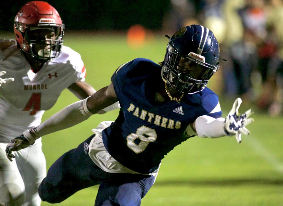 St. John Paul II junior center back Makari Vickers (8) reaches for the ball in a game against Munroe on Jan. 19, 2021 at Mike Hickman Field. The Bobcats won 19-9.