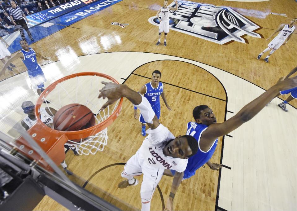 Connecticut forward DeAndre Daniels (2) dunks the ball in front of Kentucky's Dakari Johnson, right, and Andrew Harrison (5) during the first half of the NCAA Final Four tournament college basketball championship game Monday, April 7, 2014, in Arlington, Texas. (AP Photo/Chris Steppig, Pool)