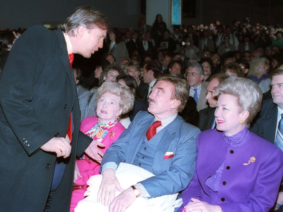 Donald Trump talks with his parents, Mary and Fred and his sister Maryanne Trump Barry (l-r), at the opening of Trump's Taj Mahal Casino Resort, Atlantic City, photo